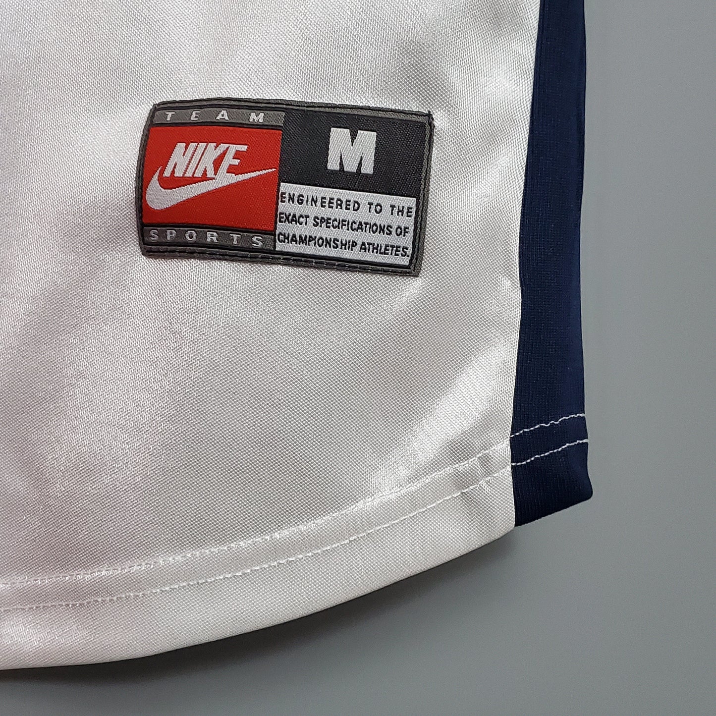 Detalle etiqueta Nike Team Sports talla M en camiseta de fútbol europea, Reino del Futbol