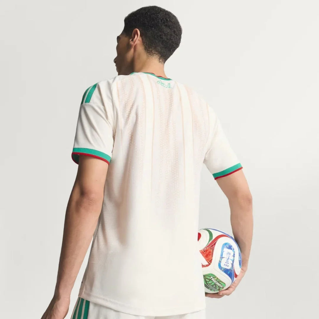 Jugador con camiseta blanca de Argelia 2026 y balón de fútbol oficial, fondo blanco, Reino del Futbol.