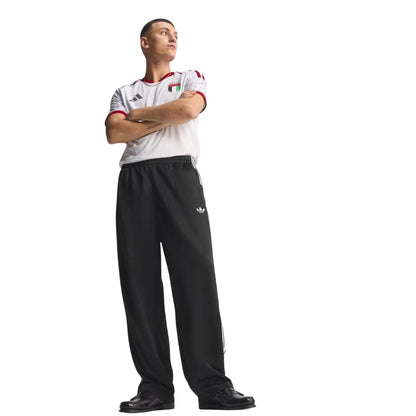 Hombre con camiseta blanca de fútbol temática y pantalón negro Adidas, fondo blanco, Reino del Futbol