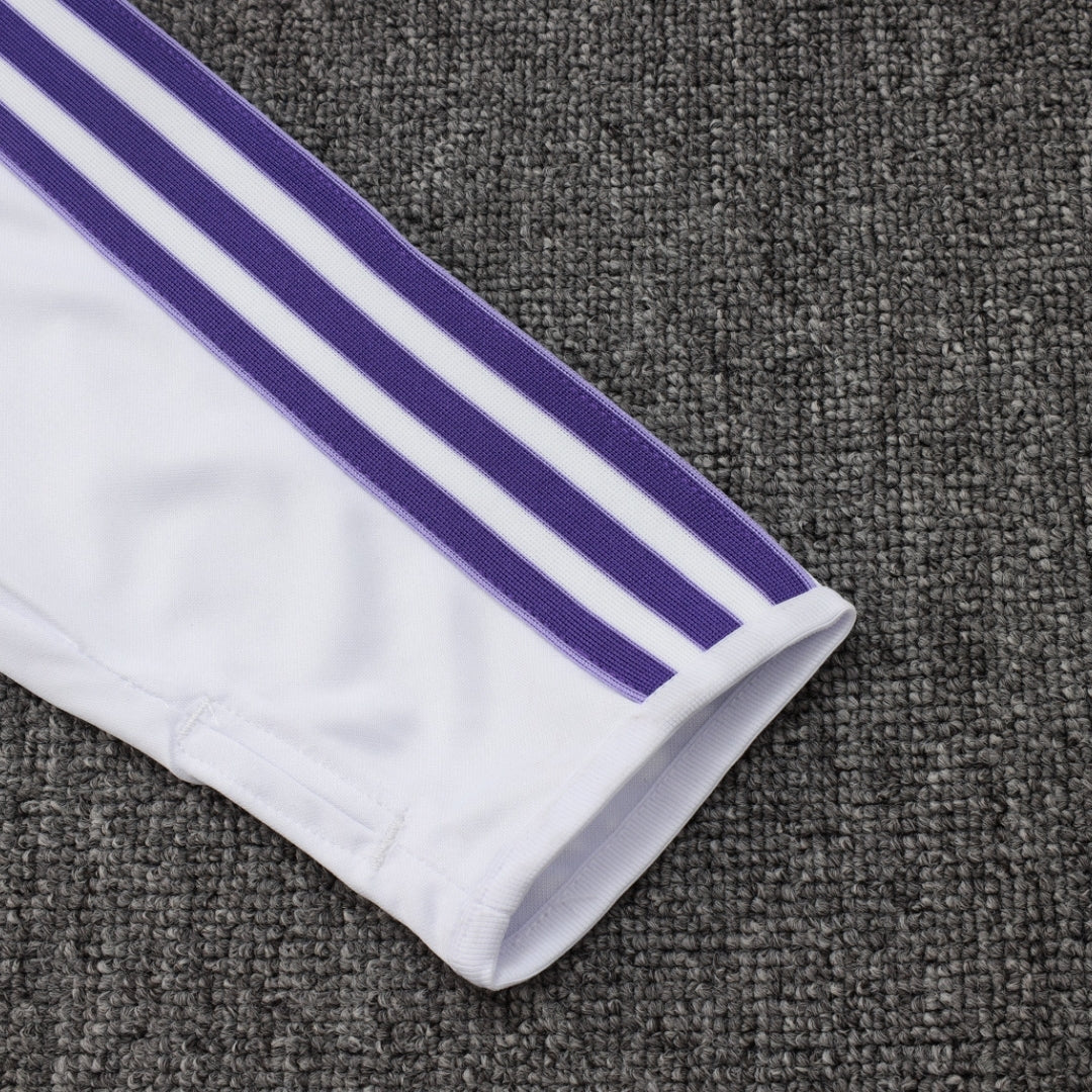 Manga de chaqueta blanca con franjas moradas en fondo gris, moda fútbol Reino del Futbol