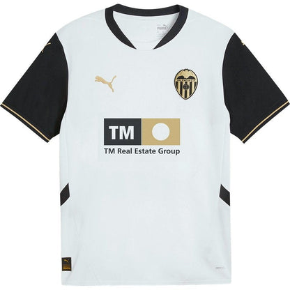 Camiseta Valencia CF 2024-2025 local, blanca con detalles negros y dorados, logo Puma y sponsor TM Real Estate, disponible en Reino del Futbol.